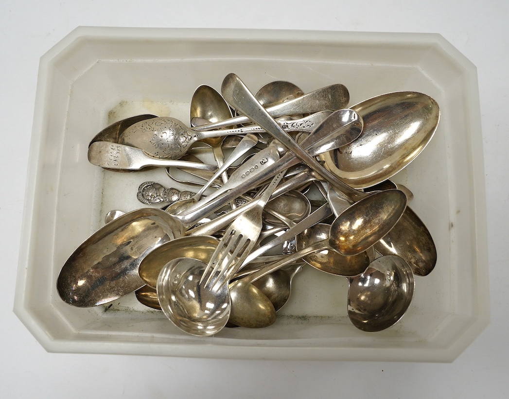 An early 18th century Hanovarian rat-tail pattern table spoon, indistinct marks, 19.6cm and a small quantity of later assorted silver flatware, 21.7oz. Condition - poor to fair